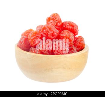 Dried red prunes fruits (Preserved fruits Chinese plum) in wooden bowl isolated on white background, save clipping path. Stock Photo