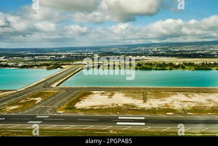 Aerial View of the Runway at Honolulu International Airport with view facing towards Pearl City on the Island of Oahu, Hawaii Stock Photo