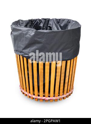 Wooden trash can with black bag isolated on white background, Save clipping path. Stock Photo