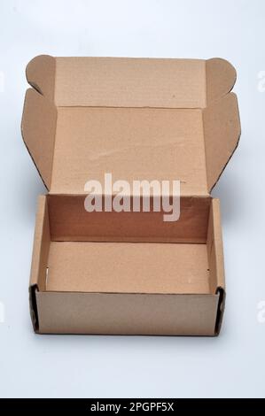 Open cardboard box light brown color white background Stock Photo