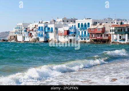 Panoramic view from the sea of Chora's white houses with colorful rooftop terraces for relaxing summer vacations on the Greek island Stock Photo