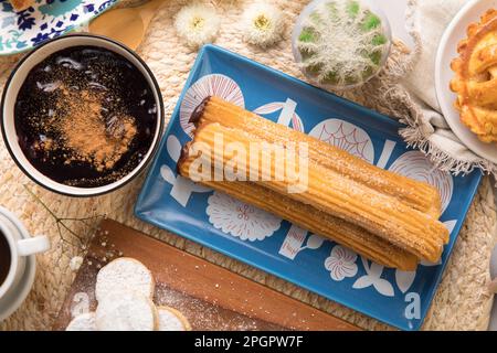 Churros and mazamorra Peruvian desserts buffet table brunch sweet food Stock Photo