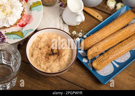 Arroz con leche and churros Peruvian desserts buffet table brunch sweet food Stock Photo