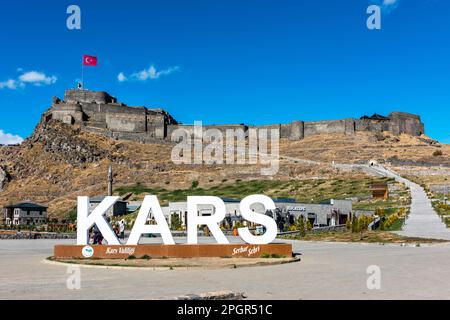 Kars, Turkey - October 25, 2022: Castle of Kars (Turkish: Kars Kalesi) view with blue sky. Castle is a former fortification located in Kars, Turkey. Stock Photo