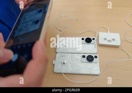 SHANGHAI, CHINA - MARCH 24, 2023 - Customers try Huawei's new P60 and Mate X3 foldable phones at the Huawei global flagship store on Nanjing Road Pede Stock Photo