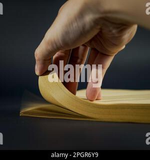 Stack of brown colored paper with hand on frame Stock Photo