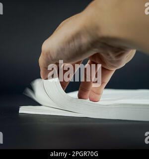 Stack of white colored paper with hand on frame Stock Photo