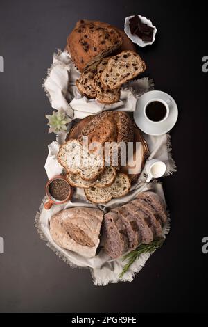 Different Types of loafes of artesan bread on a black board Stock Photo
