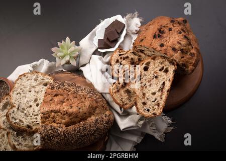 Different Types of loafes of artesan bread on a black board Stock Photo