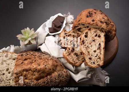 Different Types of loafes of artesan bread on a black board Stock Photo
