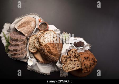 Different Types of loafes of artesan bread on a black board Stock Photo