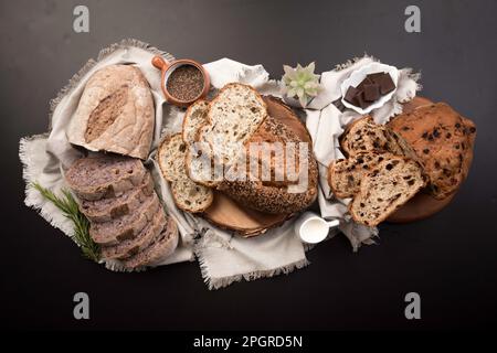 Different Types of loafes of artesan bread on a black board Stock Photo