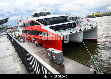 Hamburg, Germany. 24th Mar, 2023. The Helgoland catamaran before departure at the Landungsbrücken. The winter break is over: The Helgoland catamaran 'Halunder Jet' started the new season on Friday. Until October 31, it will sail daily from Hamburg and Cuxhaven to the North Sea island of Helgoland. Credit: Jonas Walzberg/dpa/Alamy Live News Stock Photo