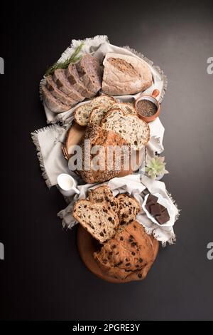 Different Types of loafes of artesan bread on a black board Stock Photo