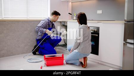Plumber Cleaning Pipe Drain Clog. Unclog Sewer Stock Photo