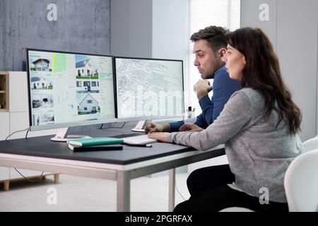 Developer Looking At Land Plot Map And Cadastre Plan Stock Photo