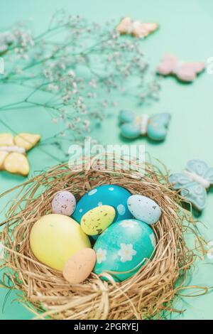 Easter banner on a green background. Easter eggs and cookies in the shape of a rabbit and a butterfly. Easter concept. Stock Photo