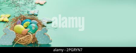 Easter banner on a green background. Bird's nest with Easter eggs. Happy Easter. Stock Photo