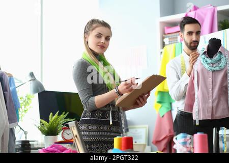 Two fashion designers man and woman are working on new collection of clothes Stock Photo