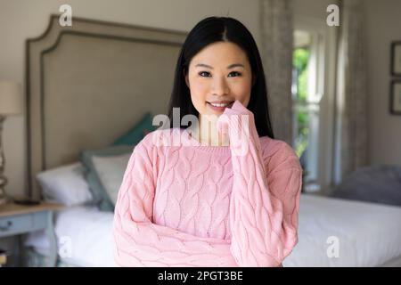 Asian Kitchen Portrait of Asian woman in sweater playing kalimba music box at city ...