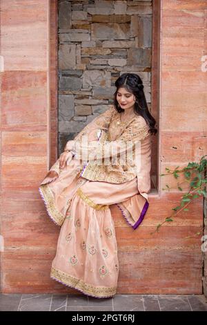 Islamabad, Pakistan, 15th March, 2023. Female model posing outdoors wearing summer dress Indian Pakistani Asian traditional salwar kameez Stock Photo