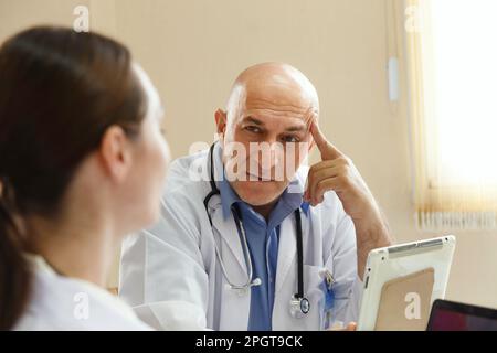 Team doctor talking and discussing in surgery treatment patient’s case in meeting room office at hospital. healthcare and medical concept. Stock Photo