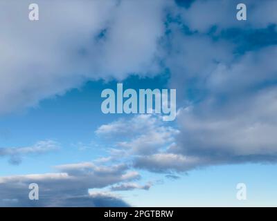 Vast blue sky filled with scattered white and gray clouds during daytime Stock Photo
