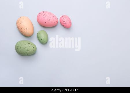 Frame from multicolored eggs on blue background.Easter concept. Stock Photo
