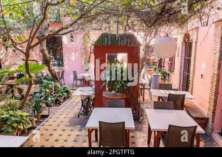 Beautiful empty restaurant terrace in the Santa Cruz neighborhood, in Seville city old center, Andalusia, Spain Stock Photo