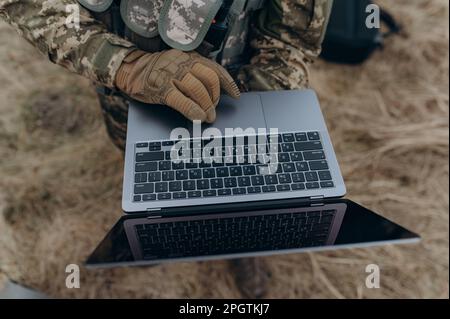 A soldier works on his laptop. Stock Photo