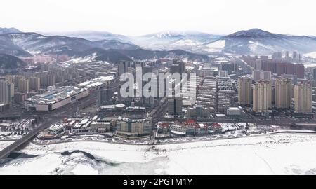 (230324) -- CHANGCHUN, March 24, 2023 (Xinhua) -- This aerial photo taken on Feb. 10, 2023 shows a general view of downtown Tonghua and Wanfeng Ski Resort, northeast China's Jilin Province. With its unique natural conditions, Tonghua, located in the southeastern part of Jilin Province, is one of the first cities in China to promote skiing. Jinchang Ski Resort, built in 1959, is China's first alpine ski resort.Famous for its long snow season and powder snow, Changbai Mountain in Jilin province has long been an ideal place for skiing. It has become a major destination for ski enthusiasts all ove Stock Photo