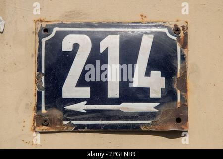 Weathered grunge square metal enameled plate of number of street address with number 214 Stock Photo