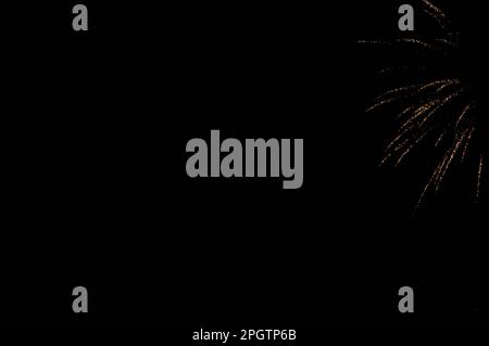 Fireworks in the night sky. New Year's celebration sparkler at night.burning sparkler for Christmas.Shiny natural fireworks on dark sky background. Stock Photo