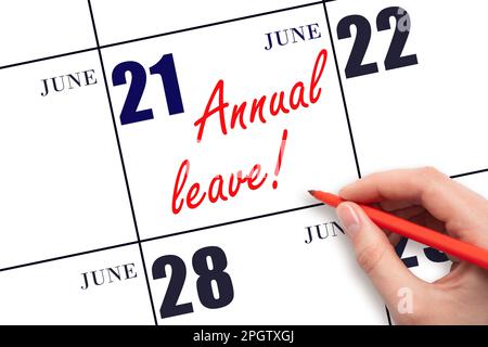 21st day of June. Hand writing the text ANNUAL LEAVE and drawing the sun on the calendar date June 21. Save the date. Time for the holidays. vacation Stock Photo