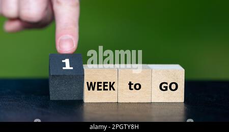 Wooden cubes form the expression '1 week to go'. Stock Photo