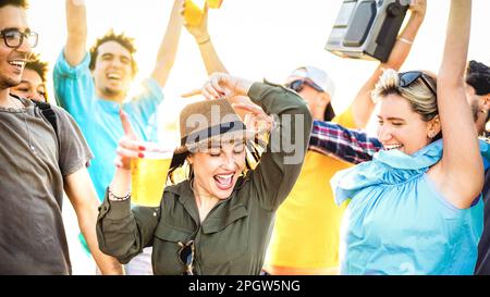 Happy fancy friends dancing at sunset on party vacation - Summer life style concept with young people having fun together at spring break festival Stock Photo