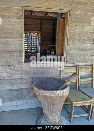 Naranjo, Costa Rica - An antique wooden coffee grinder outside a traditional Costa Rican casita (farmhouse) at the Espiritu Santo coffee farm and proc Stock Photo