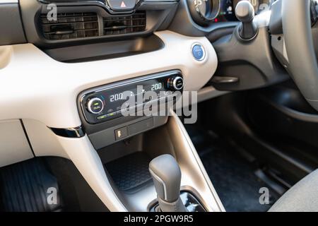 Interior of a Japenese-built, new technology hybrid small car. Showing part of the auto transmission and air conditioning system which has been set. Stock Photo