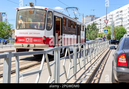 Samara, Russia - June 25, 2022: City tram stands at a public transport stop on a city street Stock Photo