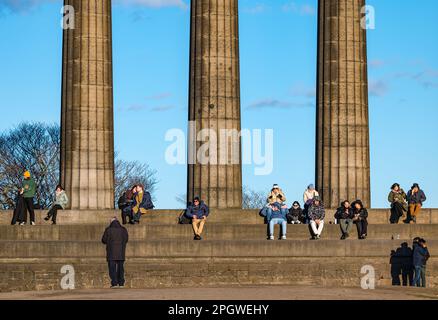 Tourists sitting on the National Monument, Calton Hill, Edinburgh, Scotland, UK Stock Photo