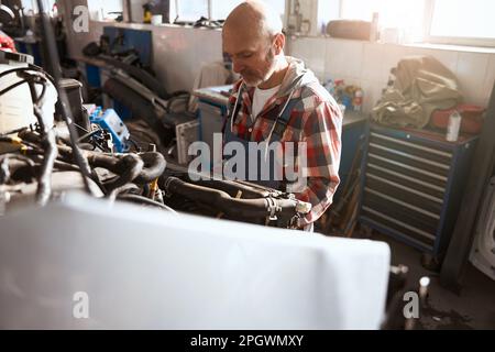 Auto repairman repairs a modern car after an accident Stock Photo
