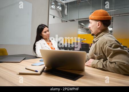 Two office workers communicating in meeting room Stock Photo
