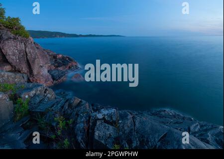 Dusk over the granite rocks of the Canadian Shield rocks and the waters ...