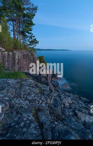 Dusk over the granite rocks of the Canadian Shield rocks and the waters ...