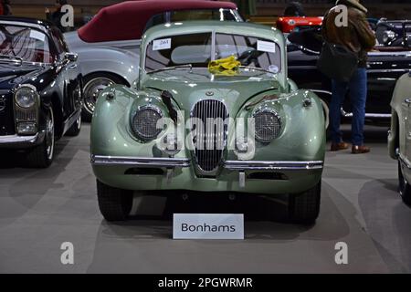 Paris, France - February 4, 2020: Bonhams 2020 sale at the Grand Palais in Paris. Focus on a green 1952 Jaguar XK120 Coupé. Chassis no. 680421. Stock Photo