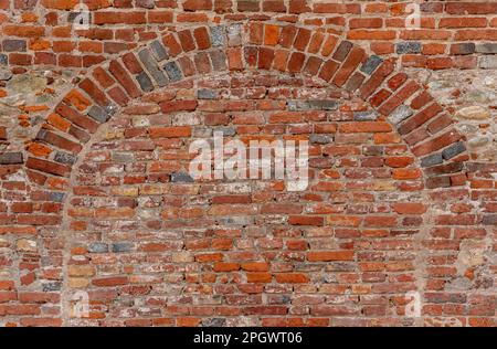 Wall texture with geometry with old red brick, brick wall with red e gray brick archway Stock Photo