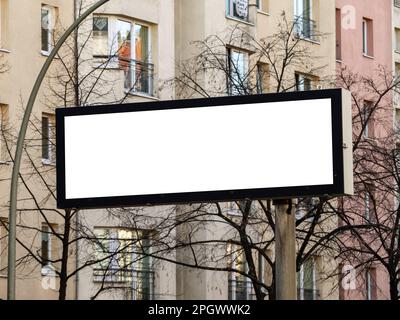 Empty billboard space in an urban area. Blank white screen in landscape format to display information or advertising to the road user in the city. Stock Photo