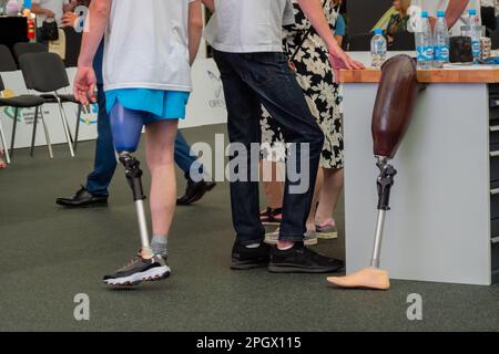 Group of people standing at competition for disabled persons with leg prosthesis Stock Photo