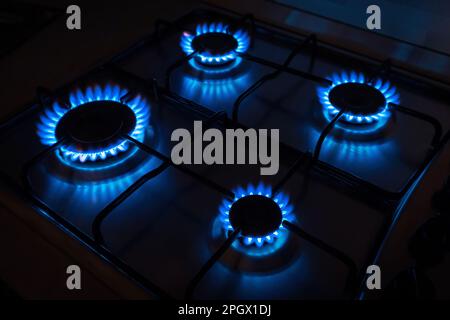 Domestic gas cooker with burners lit Stock Photo