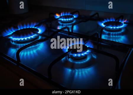 Domestic gas cooker with burners lit Stock Photo